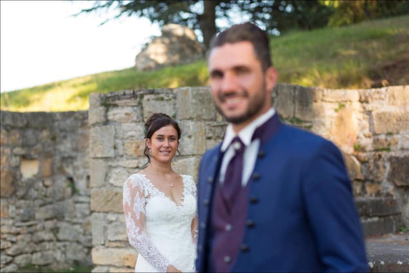 La mariée au second plan avec le marié flou devant