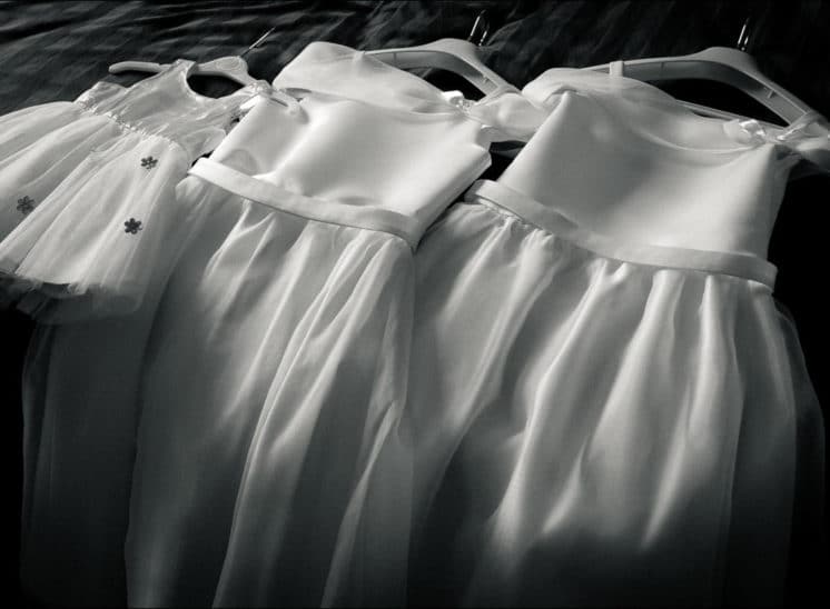 Les robes des filles de la mariée alignées sur le lit